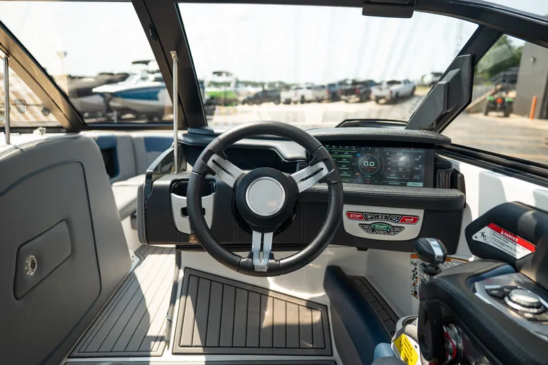 Slide: The Image of 2019 Nautique Super Air Nautique G23 boat dashboard with steering wheel and digital display. - 32