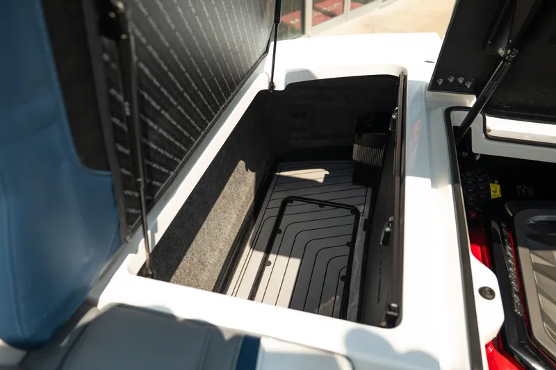Slide: The Image of 2019 Nautique Super Air Nautique G23 storage compartment with open hatch, showcasing interior space. - 28