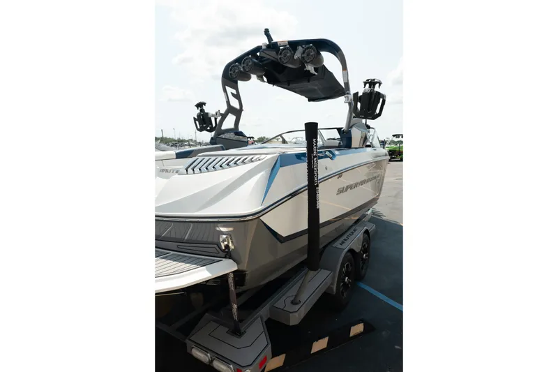 Slide: The Image of 2019 Nautique Super Air Nautique G23 boat on trailer, featuring sleek design and advanced wakeboard tower. - 8