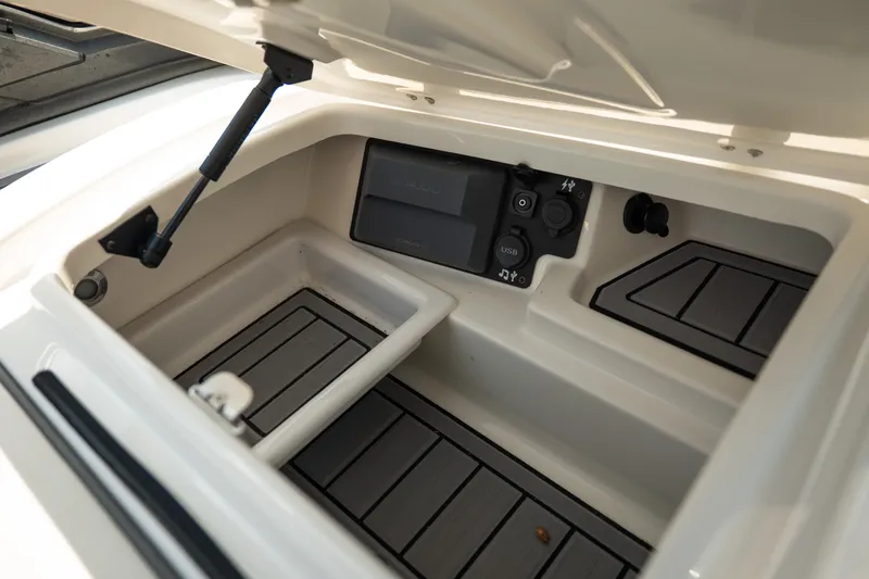 Slide: The Image of 2019 Nautique Super Air Nautique G23 storage compartment with USB and audio controls. - 45