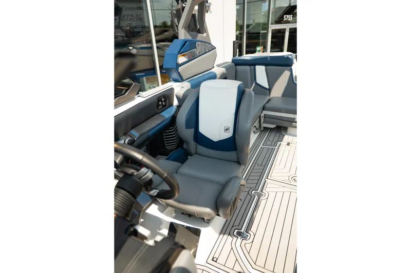 Slide: The Image of 2019 Nautique Super Air Nautique G23 interior with blue and gray seating and modern dashboard. - 43