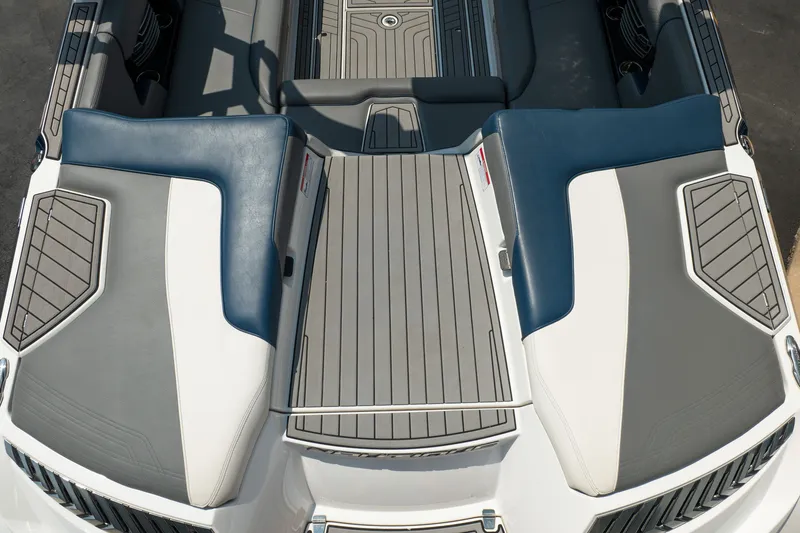 Slide: The Image of 2019 Nautique Super Air Nautique G23 boat interior with gray and blue seating. - 17