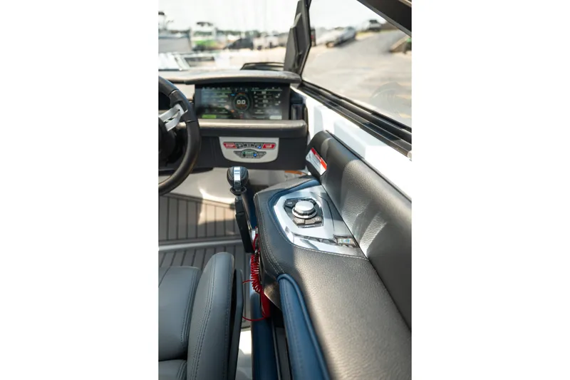 Slide: The Image of 2019 Nautique Super Air Nautique G23 boat dashboard with modern controls and steering wheel. - 33