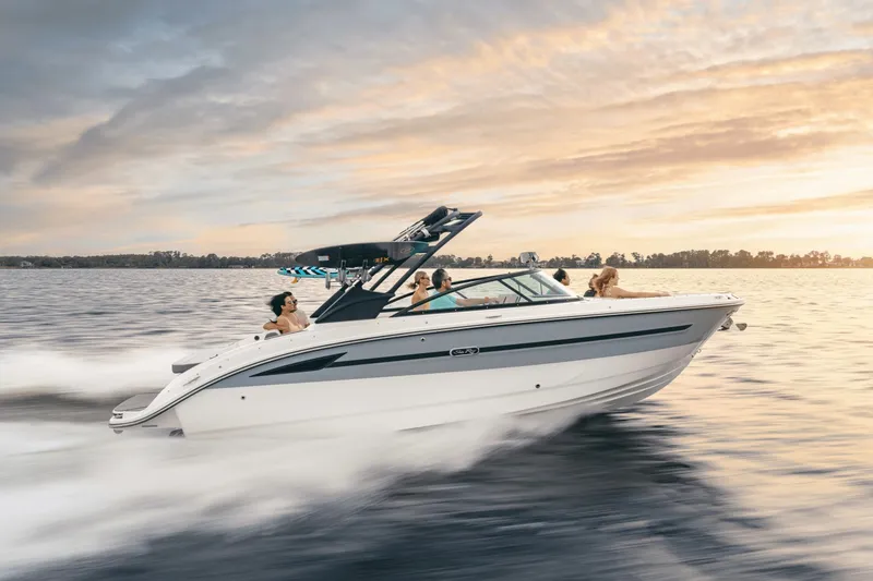 Slide: The Image of A sleek, modern motorboat speeds across the water at sunset. - 2