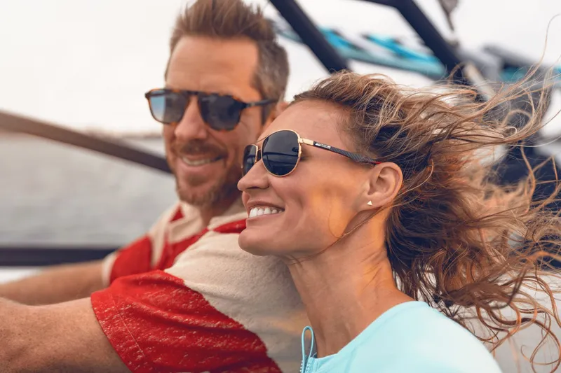 Slide: The Image of A couple enjoys a boat ride, smiling with windblown hair. - 11