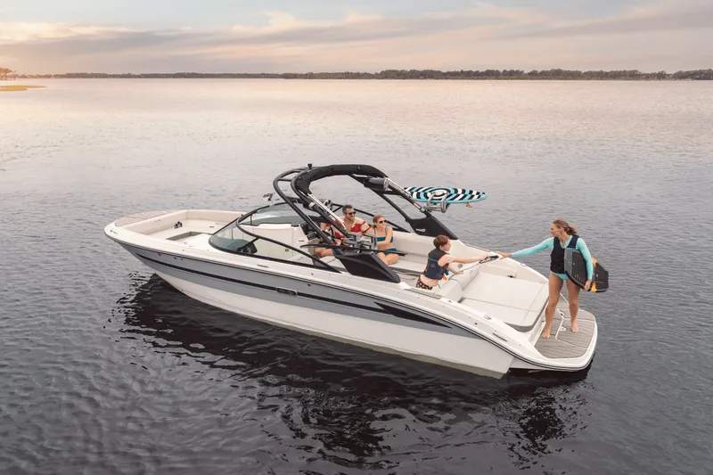 Slide: The Image of A modern Sea Ray SDX 270 Surf on calm water with several people on board. - 5