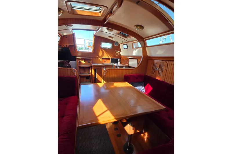 Slide: The Image of Interior of 1989 Fairweather Mariner 39 yacht with wooden finishes and red seating. - 26