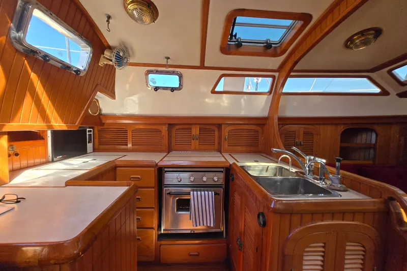 Slide: The Image of Luxurious wooden yacht kitchen interior with modern appliances, Fair Weather Mariner 39, 1989 model. - 21