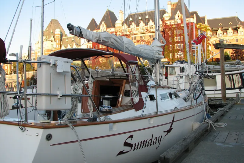 Slide: The Image of Sailboat "Sumday" docked, Fair Weather Mariner 39, 1989, with historic buildings in the background. - 14