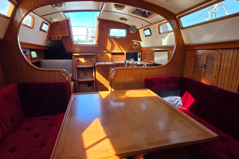 Slide: The Image of Cozy interior of 1989 Fairweather Mariner 39 yacht with wooden furnishings and plush seating. - 25