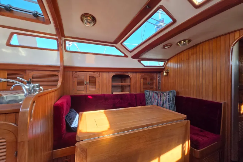 Slide: The Image of Luxurious 1989 Fair Weather Mariner 39 yacht interior with wood paneling and plush seating. - 19