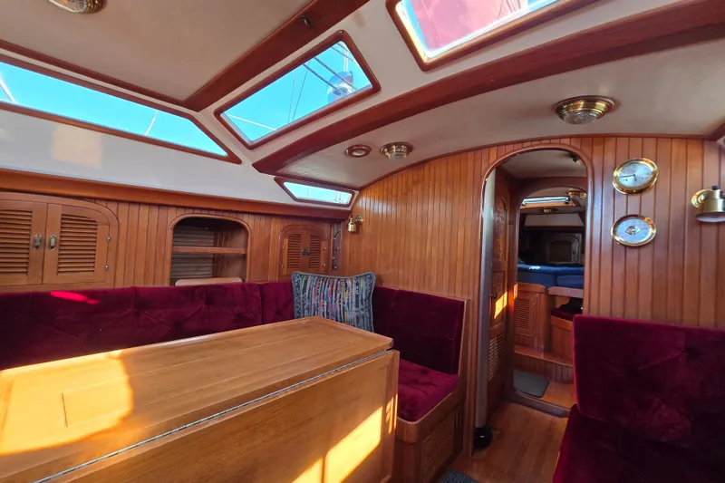 Slide: The Image of Interior of 1989 Fair Weather Mariner 39 sailboat with wood paneling and plush seating. - 18