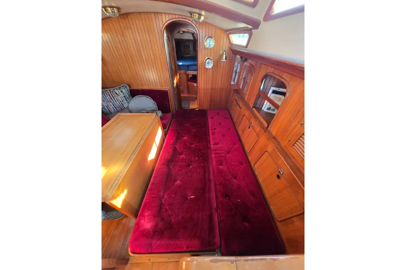 Slide: The Image of Interior of 1989 Fairweather Mariner 39 yacht with plush red seating and wooden cabinetry. - 22