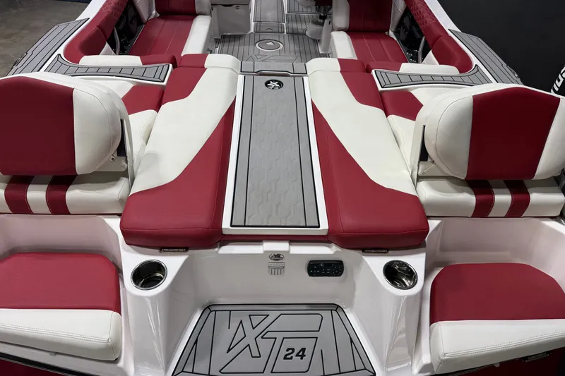 Slide: The Image of 2024 MasterCraft XT24 boat interior with red and white seating and sleek design. - 13