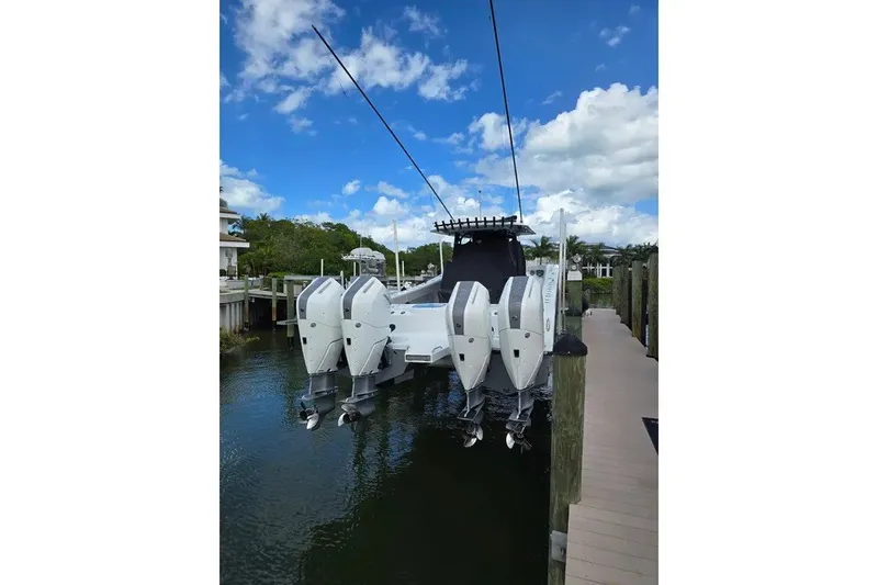 Slide: The Image of 2024 Freeman 47 boat with four powerful outboard engines docked by a pier. - 5