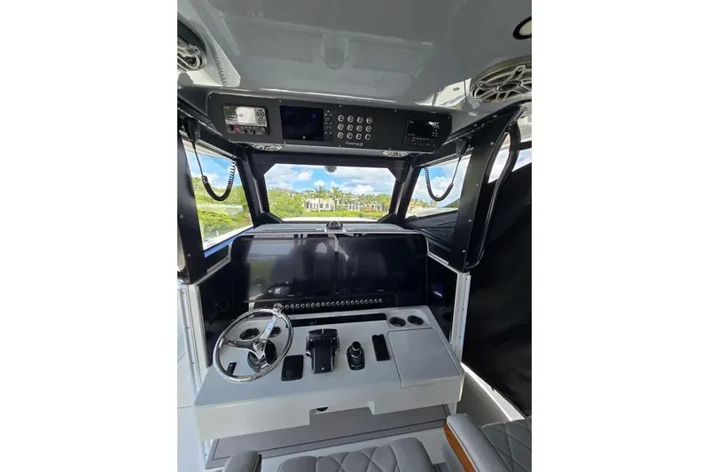 Slide: The Image of Interior view of 2024 Freeman 47 boat cockpit with modern controls and steering wheel. - 7