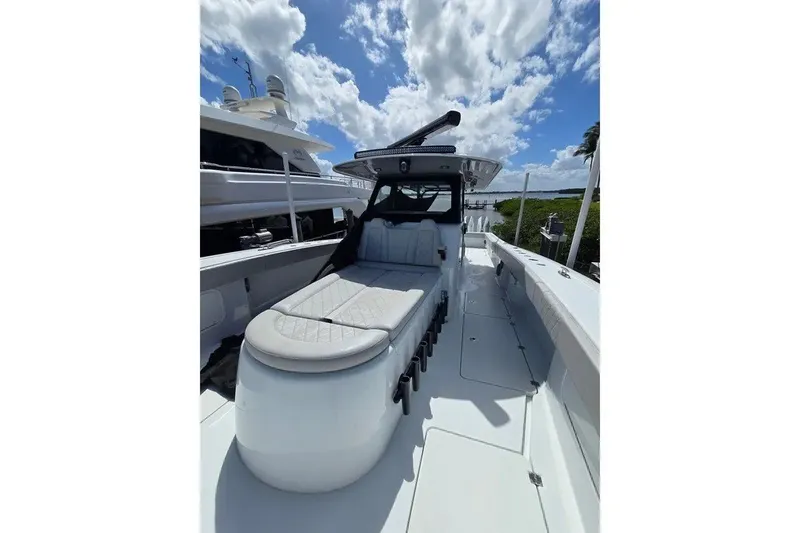 Slide: The Image of 2024 Freeman 47 boat with sleek design, spacious deck, and luxurious seating under a blue sky. - 11
