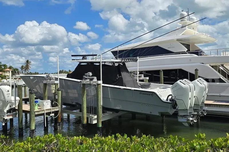 Slide: The Image of 2024 Freeman 47 boat docked with powerful engines, under a clear blue sky. - 3