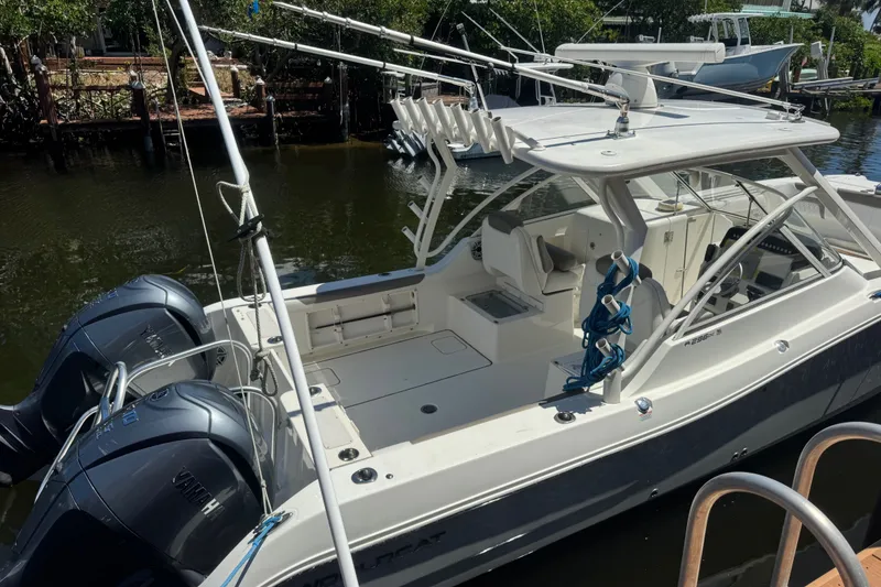 Slide: The Image of 2022 World Cat 296 DC boat with dual engines docked in a serene marina. - 4