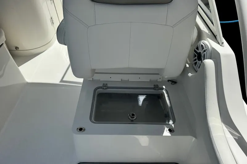 Slide: The Image of 2022 World Cat 296 DC boat interior with storage compartment under seat. - 26
