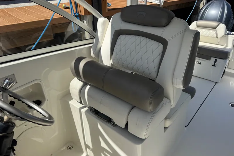 Slide: The Image of 2022 World Cat 296 DC boat interior with luxurious seating and steering wheel. - 17