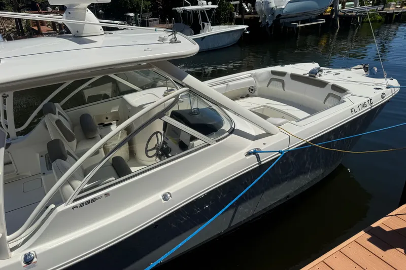 Slide: The Image of 2022 World Cat 296 DC boat docked in a marina, showcasing sleek design and spacious seating. - 5