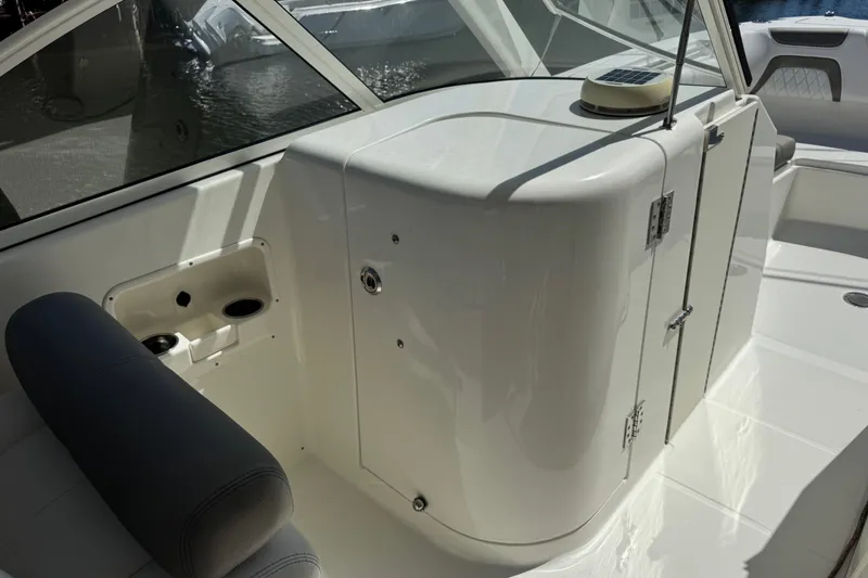 Slide: The Image of 2022 World Cat 296 DC boat interior with seating and storage compartment. - 13