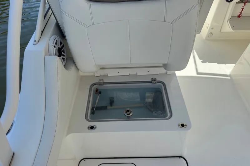 Slide: The Image of 2022 World Cat 296 DC boat seat with storage compartment open. - 25