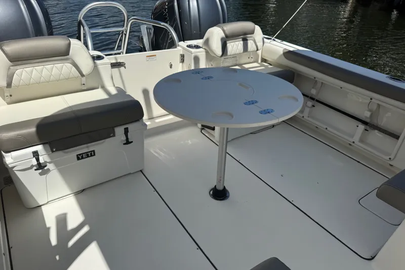Slide: The Image of Interior of 2022 World Cat 296 DC boat with seating and table setup. - 8