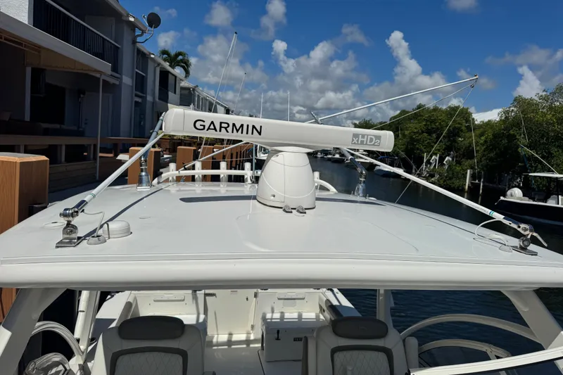 Slide: The Image of 2022 World Cat 296 DC boat with Garmin xHD2 radar on top, docked by waterfront homes. - 31