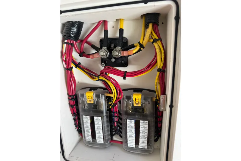 Slide: The Image of Electrical wiring and fuse box inside a 2022 World Cat 296 DC boat. - 34
