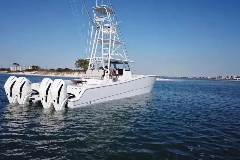Slide: The Image of 2023 Freeman 47 boat with four engines on calm water, clear sky background. - 6