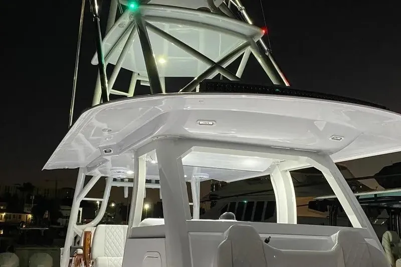 Slide: The Image of 2023 Freeman 47 boat at night, featuring illuminated tower and sleek design. - 9