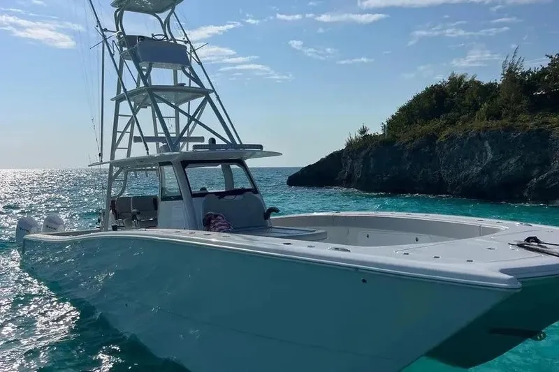 Slide: The Image of 2023 Freeman 47 boat on clear turquoise water near rocky shoreline. - 3