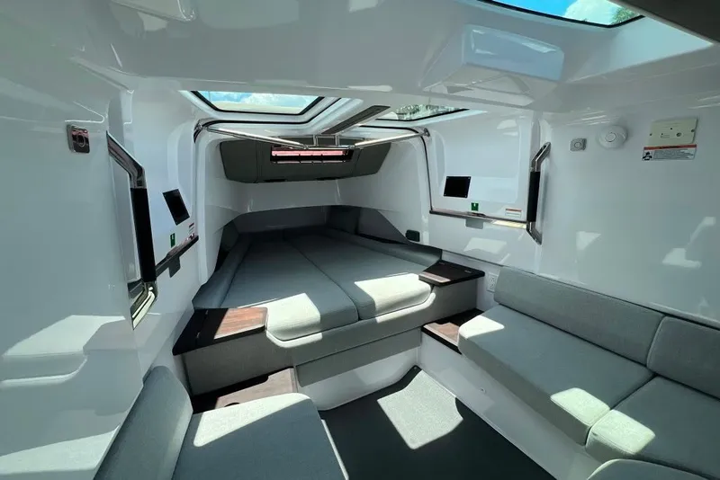 Slide: The Image of 2023 Axopar Brabus 37 Sun-Top cabin interior with modern seating and skylight. - 19