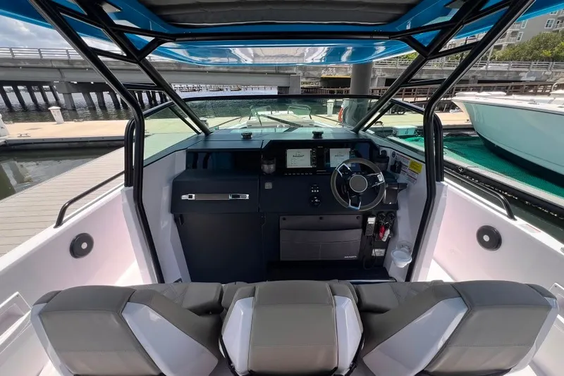 Slide: The Image of 2023 Axopar Brabus 37 Sun-Top boat interior with modern dashboard and seating. - 56