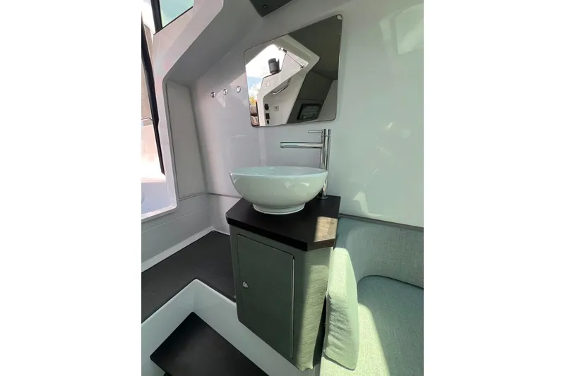 Slide: The Image of Interior of 2023 Axopar Brabus 37 Sun-Top, featuring modern sink and mirror setup. - 17