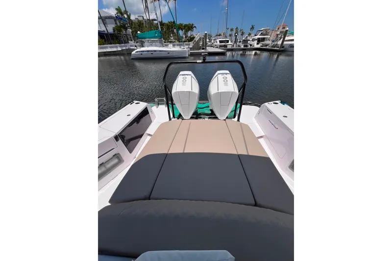 Slide: The Image of 2023 Axopar Brabus 37 Sun-Top boat with twin engines docked at marina. - 51