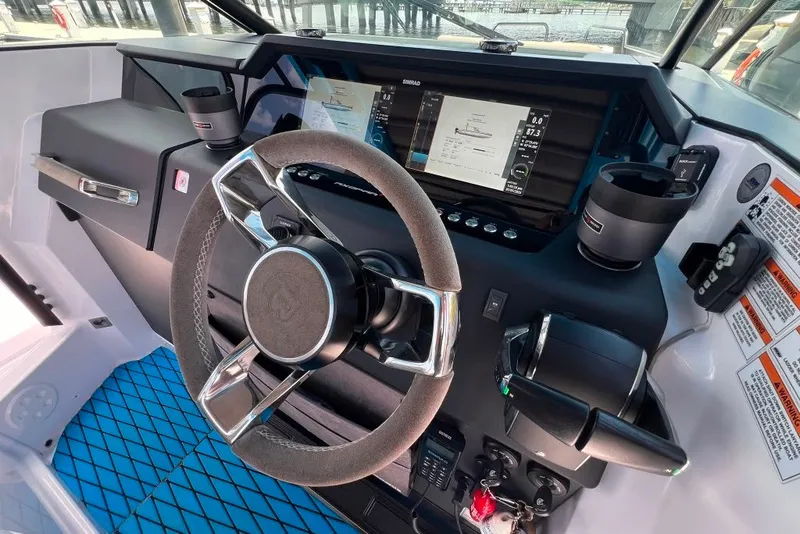 Slide: The Image of 2023 Axopar Brabus 37 Sun-Top helm with modern controls and navigation display. - 36
