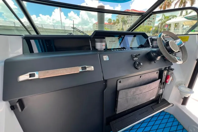 Slide: The Image of Cockpit of 2023 Axopar Brabus 37 Sun-Top with modern steering and navigation controls. - 39