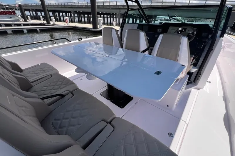 Slide: The Image of 2023 Axopar Brabus 37 Sun-Top boat interior with sleek seating and modern table design. - 43