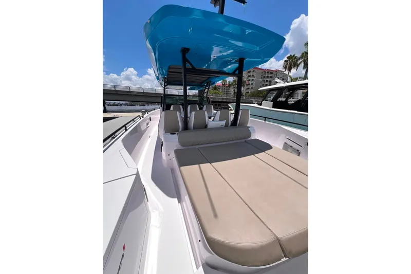 Slide: The Image of 2023 Axopar Brabus 37 Sun-Top boat with spacious seating and blue canopy. - 30