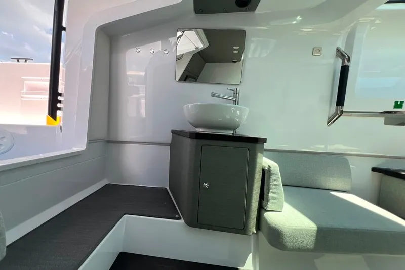 Slide: The Image of Interior of 2023 Axopar Brabus 37 Sun-Top, featuring modern sink and seating area. - 23