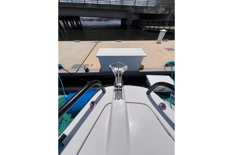 Slide: The Image of 2023 Axopar Brabus 37 Sun-Top docked near a bridge, showcasing sleek design. - 63