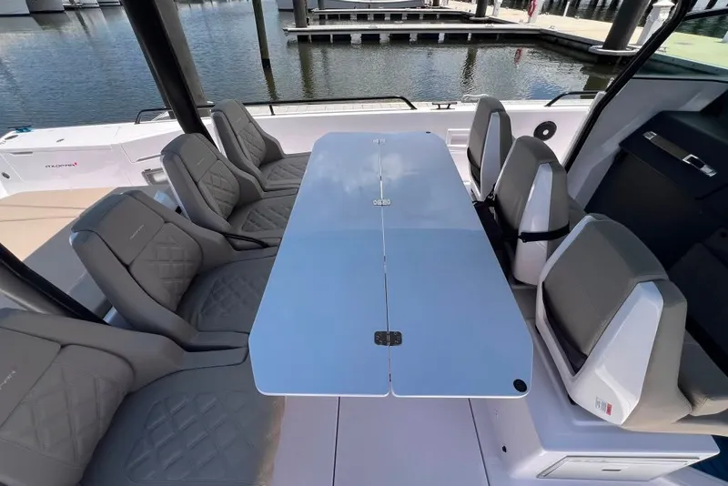 Slide: The Image of Luxurious seating area on 2023 Axopar Brabus 37 Sun-Top boat, featuring sleek design and waterfront view. - 42