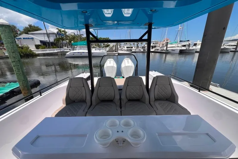 Slide: The Image of 2023 Axopar Brabus 37 Sun-Top boat interior with seating and marina view. - 53
