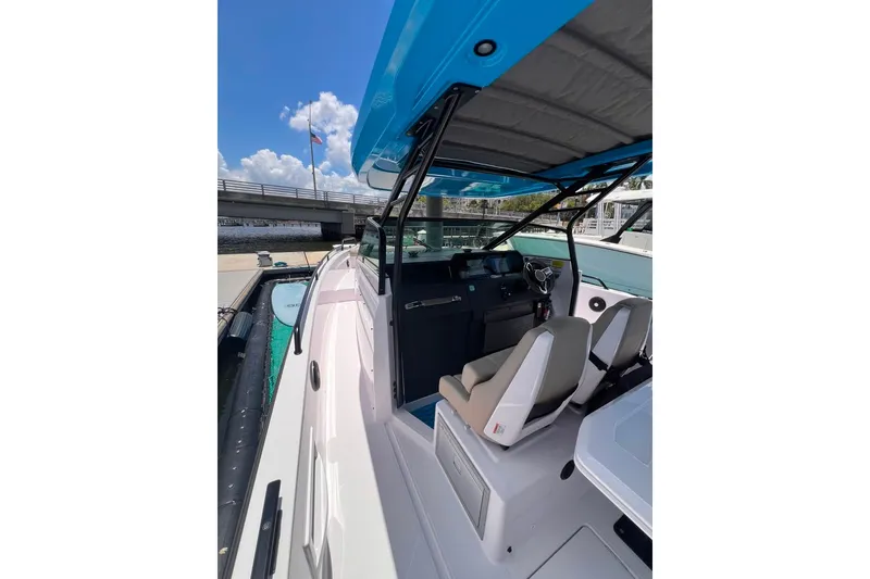 Slide: The Image of 2023 Axopar Brabus 37 Sun-Top boat interior with blue canopy and modern seating. - 59