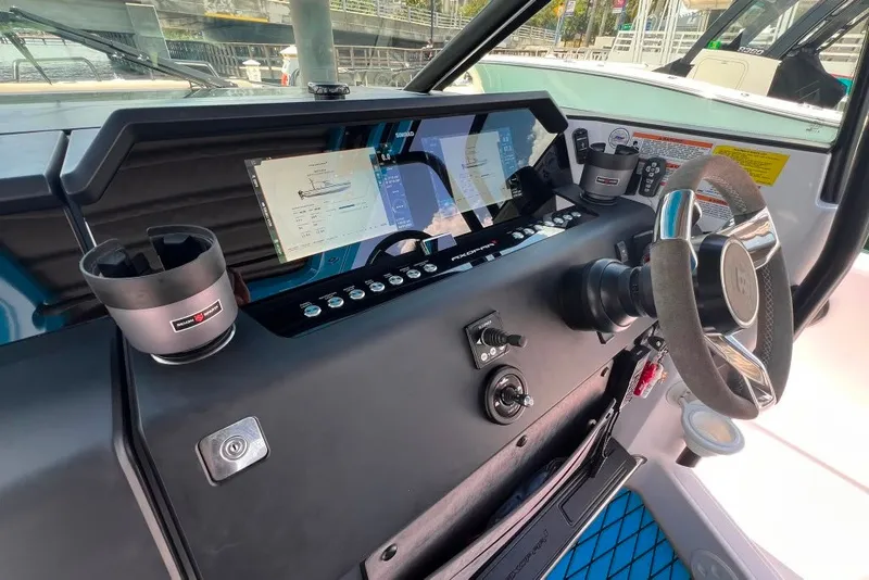 Slide: The Image of 2023 Axopar Brabus 37 Sun-Top dashboard with modern controls and steering wheel. - 47