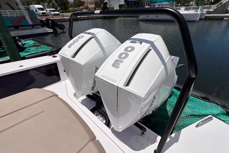 Slide: The Image of Twin Mercury outboard engines on a 2023 Axopar Brabus 37 Sun-Top boat at a marina. - 29