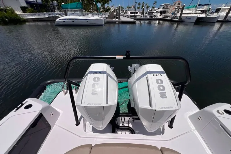 Slide: The Image of 2023 Axopar Brabus 37 Sun-Top with twin Mercury 300 engines docked at marina. - 31